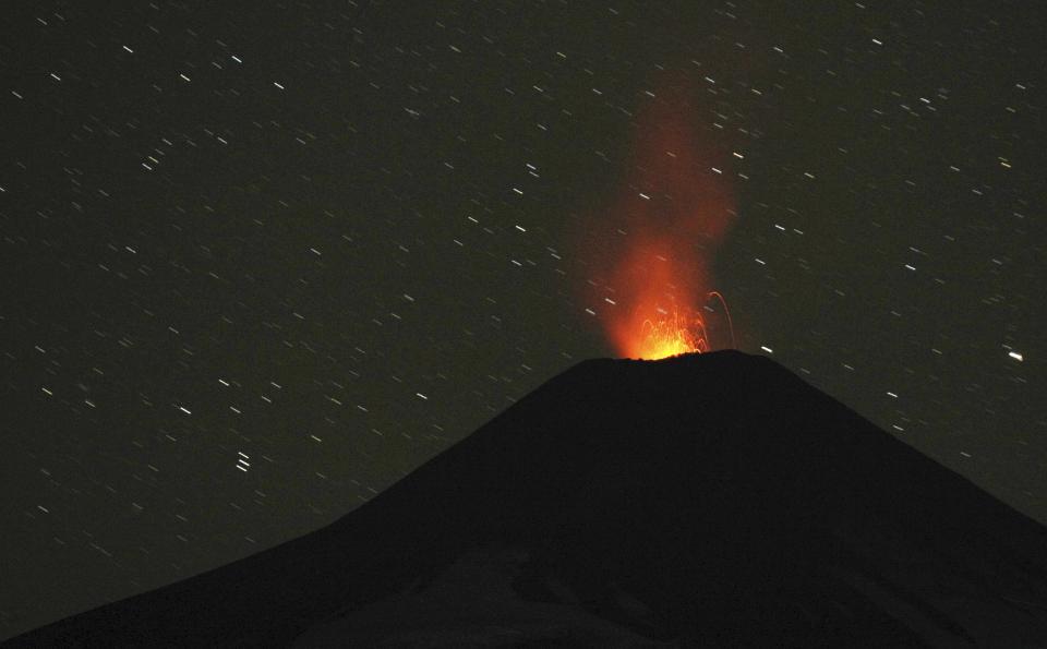 Smoke and lava spew from the Villarrica volcano, as seen from Pucon town in the south of Santiago.