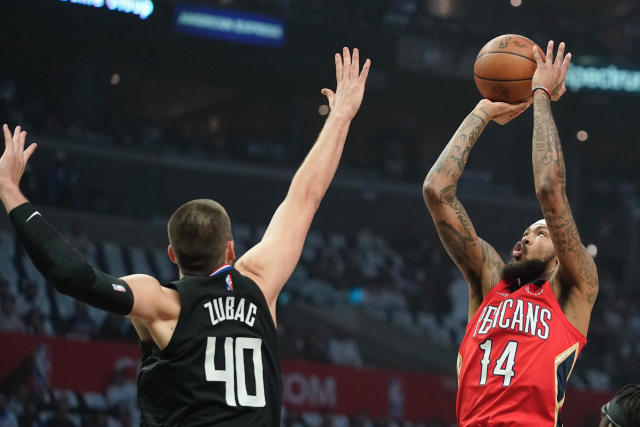 New Orleans Pelicans forward Brandon Ingram, right, shoots as Los Angeles Clippers center Ivica Zubac defends during the first half of an NBA basketball play-in tournament game Friday, April 15, 2022, in Los Angeles. (AP Photo/Mark J. Terrill)