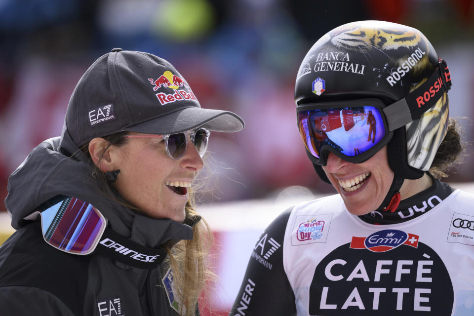 Sofia Goggia of Italy, left, and Federica Brignone of Italy, right, react in the finish area during an alpine ski, women’s World Cup downhill race in Crans Montana, Switzerland, Sunday, Feb. 26, 2023. (Alessandro della Valle/Keystone via AP)