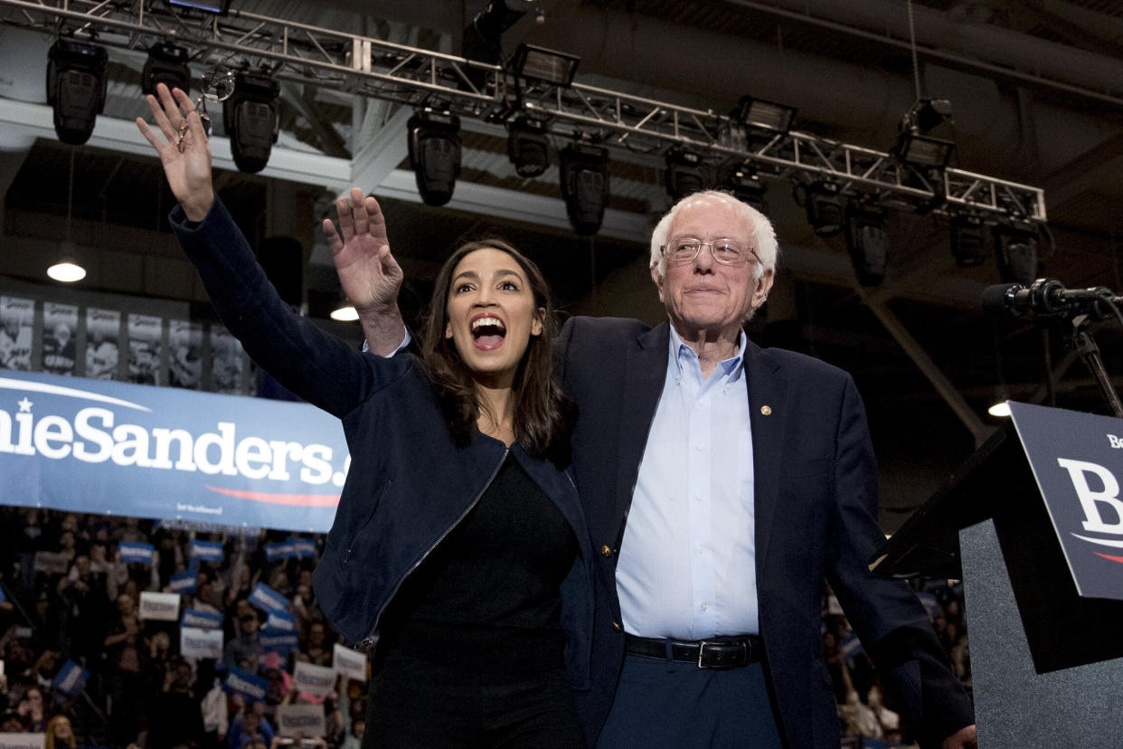 Former Democratic presidential candidate Sen. Bernie Sanders (I-Vt.) and Rep. Alexandria Ocasio-Cortez (D-N.Y.), left, take the stage at Sanders' campaign stop at the University of New Hampshire, Feb. 10. (Photo: ASSOCIATED PRESS)