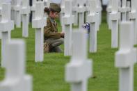 <p>A girl looks at the graves of fallen soldiers at the Normandy American Cemetery, which contains the remains of 9,387 American military dead, most killed during the invasion of Normandy and ensuing military operations in World War II.<br> (Photo: Artur Widak/NurPhoto via Getty Images) </p>