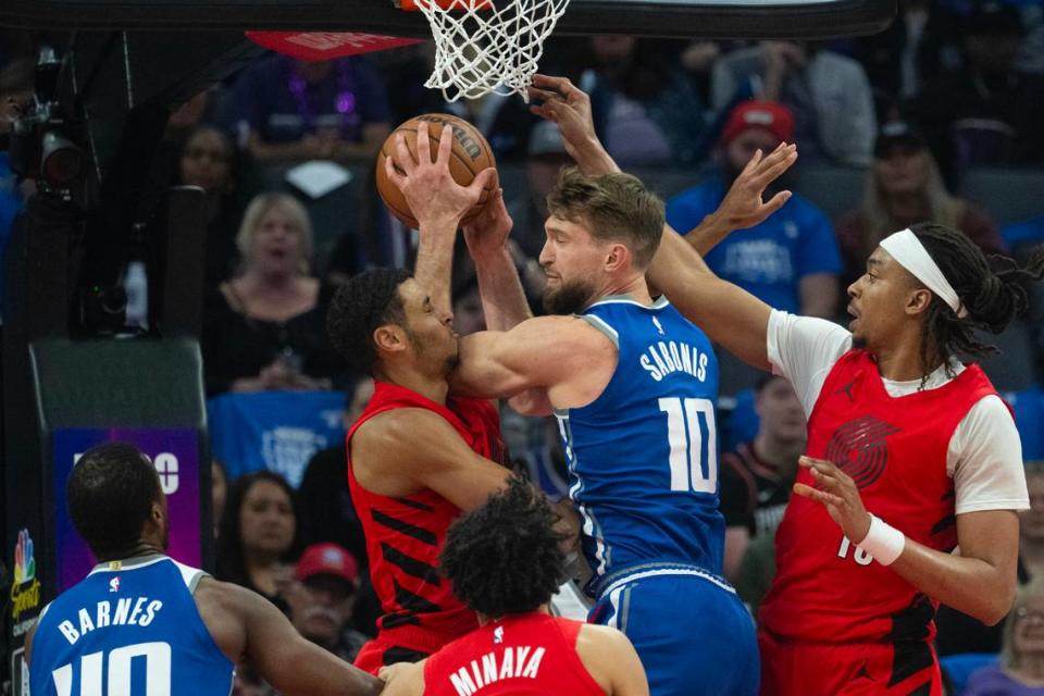 Sacramento Kings forward Domantas Sabonis (10) grabs rebound from Portland Trail Blazers forward Kris Murray (8) at Golden 1 Center on Sunday.