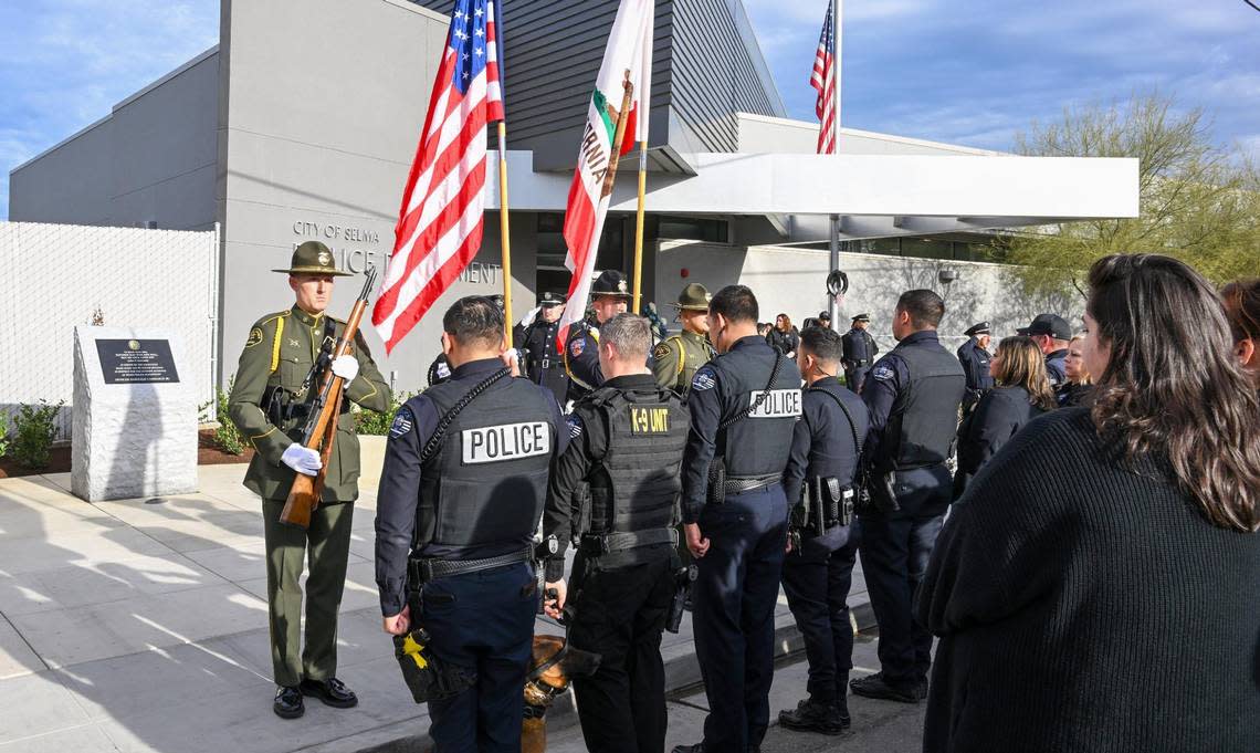 The Fresno County Sheriff’s Office color guard presents the American and California flags at the start of a service to dedicate a memorial to fallen Selma Police Officer Gonzalo Carrasco Jr. who was killed in the line of duty one year ago, at the Selma Police Department on Wednesday, Jan. 31, 2024.