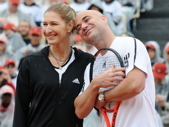 <p>Laurent ZABULON/Gamma-Rapho/Getty</p> Steffi Graf and Andre Agassi playing in Roland-Garros Tennis Tournament in 2009