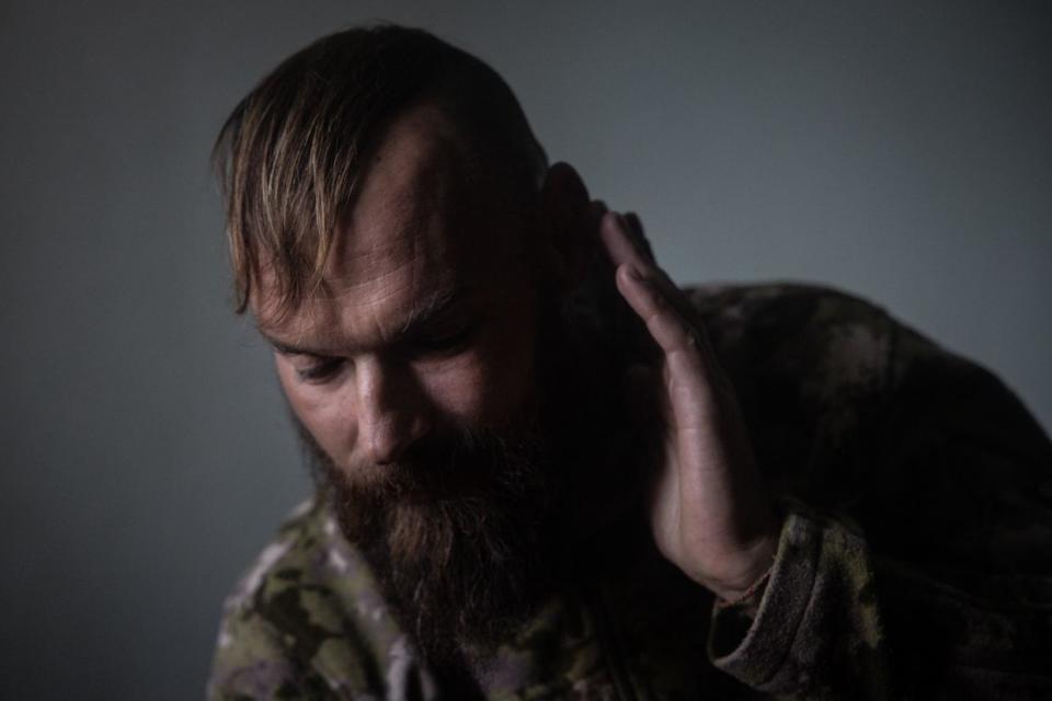 Dmytro, call sign “Casper,” a 39-year-old Ukrainian soldier, recounts front-line stories in his room at a psychiatric hospital in Kyiv, Ukraine, on Oct. 11, 2023. Dmytro joined the military after the EuroMaidan Revolution in 2014 he became famous during the revolution for fighting with police with a self-made shield. (Chris McGrath/Getty Images)