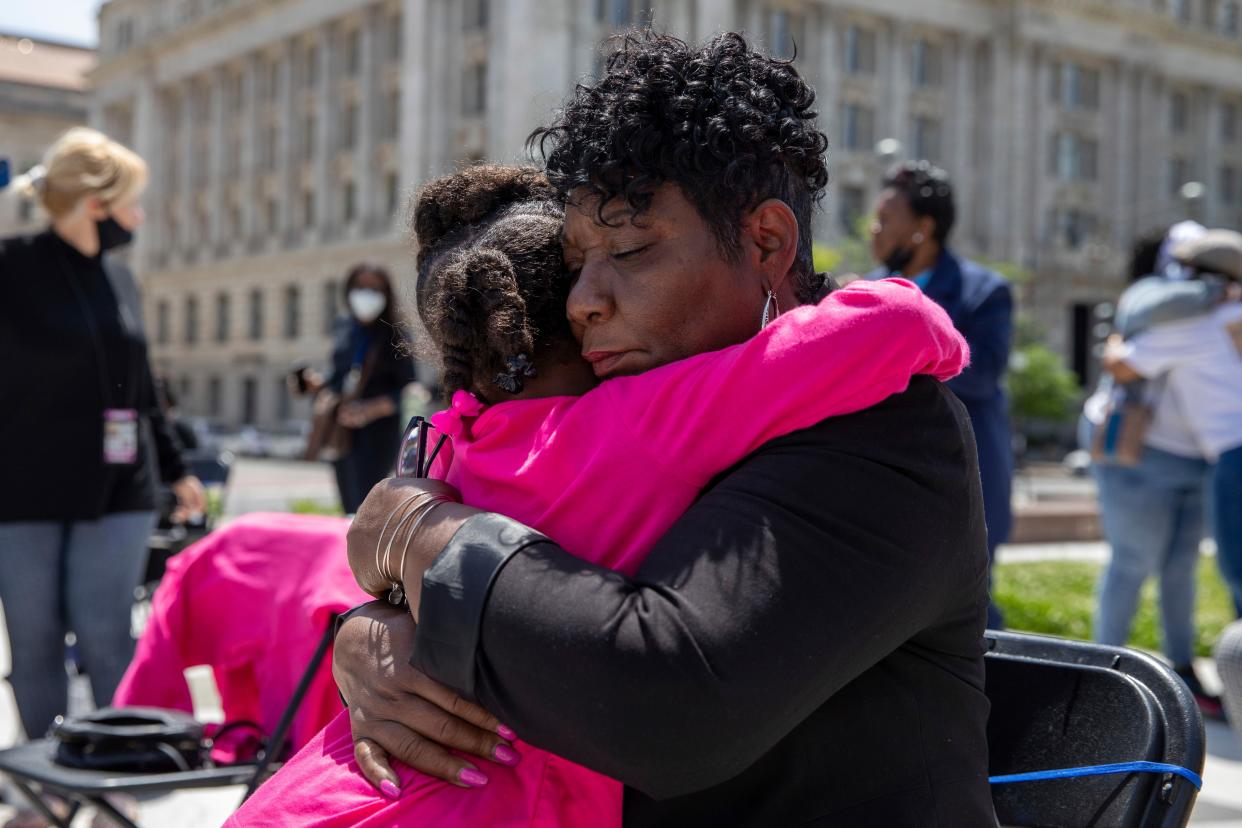 Karsyn Courtney, 5, hugs Marion Gray-Hopkins, president of the Coalition of Concerned mothers, at the Hear Our Cry rally at Freedom Plaza in Washington on Thursday, May 6. Gray-Hopkins' son, Gary Hopkins Jr., was killed by police, as was Courtney's mother, Korryn Gaines. 