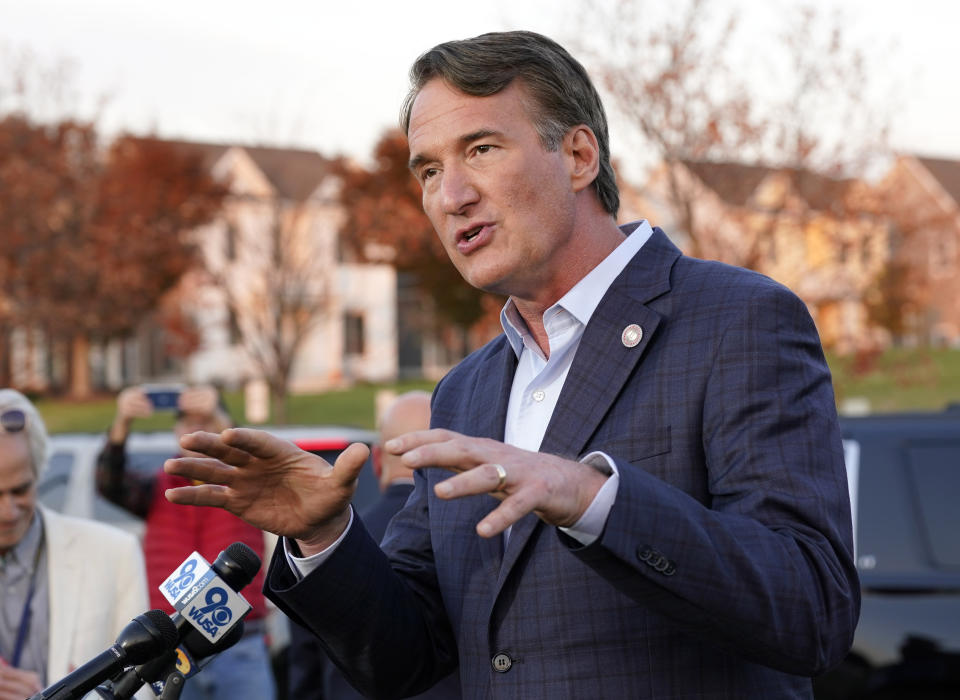 Virginia Gov. Glenn Youngkin gestures as he talks with reporters after greeting voters at a polling station during Election Day, Tuesday Nov. 7, 2023, in Glenn Allen, Va. (AP Photo/Steve Helber)