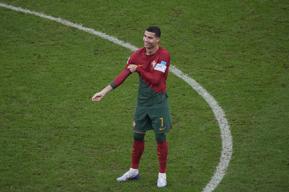 Portugal's Cristiano Ronaldo smiles ah he enters the pitch during the World Cup round of 16 soccer match between Portugal and Switzerland, at the Lusail Stadium in Lusail, Qatar, on Tuesday, Dec. 6, 2022. (AP Photo/Ariel Schalit)