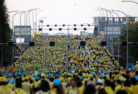 People are seen heading toward the bridge as they return from the coronation procession for Thailand's newly crowned King Maha Vajiralongkorn in Bangkok, Thailand May 5, 2019. REUTERS/Navesh Chitrakar