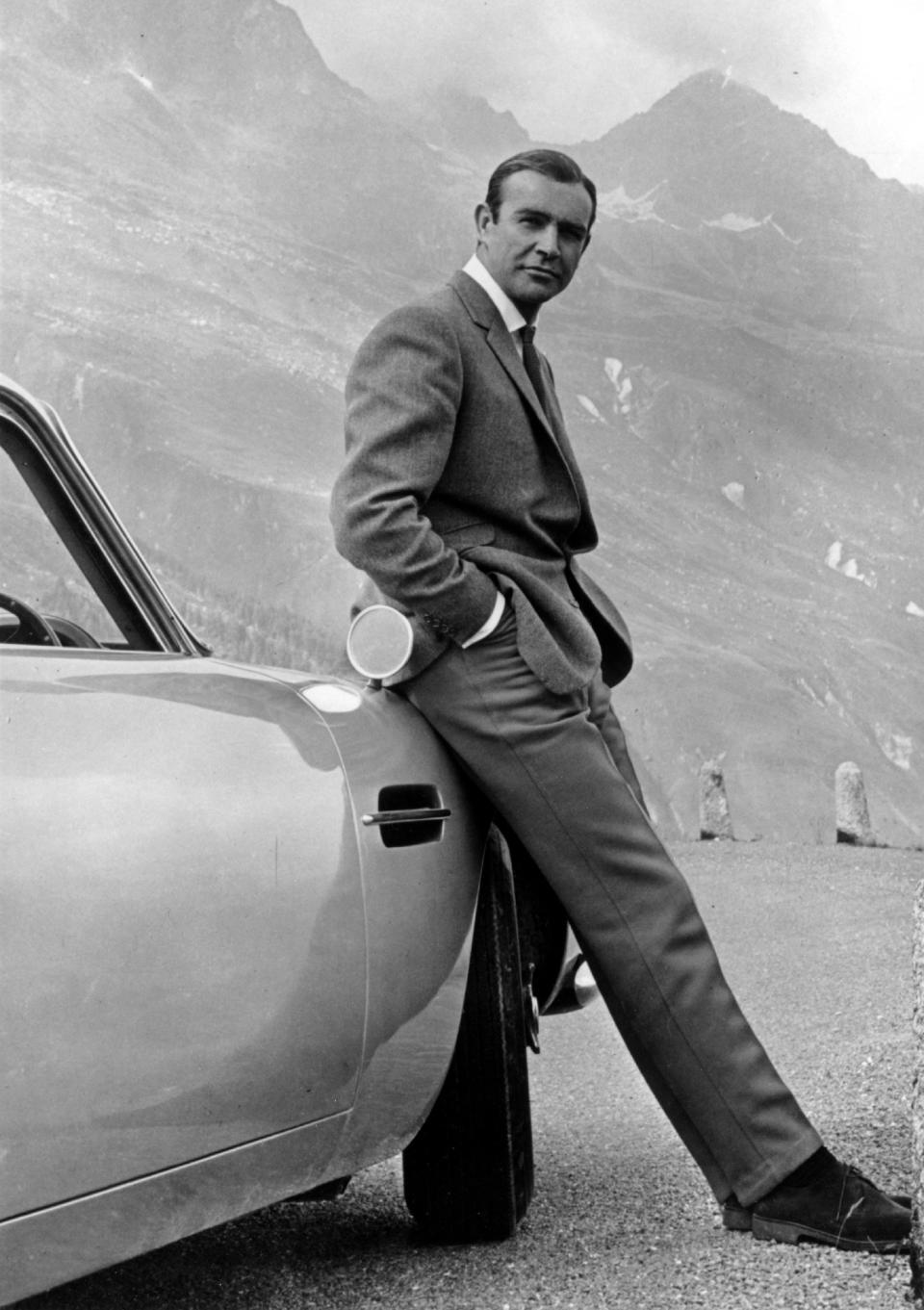 Connery as James Bond, posing next to his Aston Martin DB5 in a scene from "Goldfinger." (Photo: Michael Ochs Archives via Getty Images)