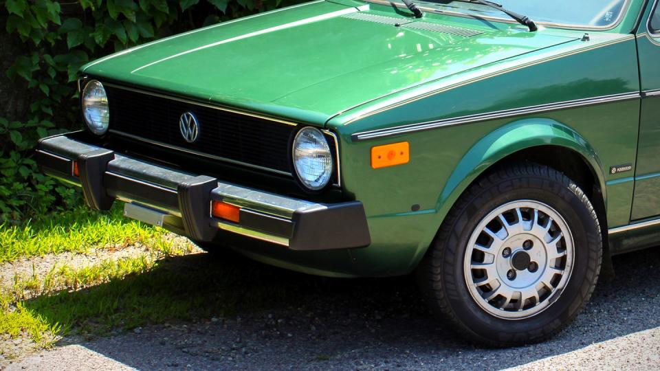 a green car parked on the side of the road