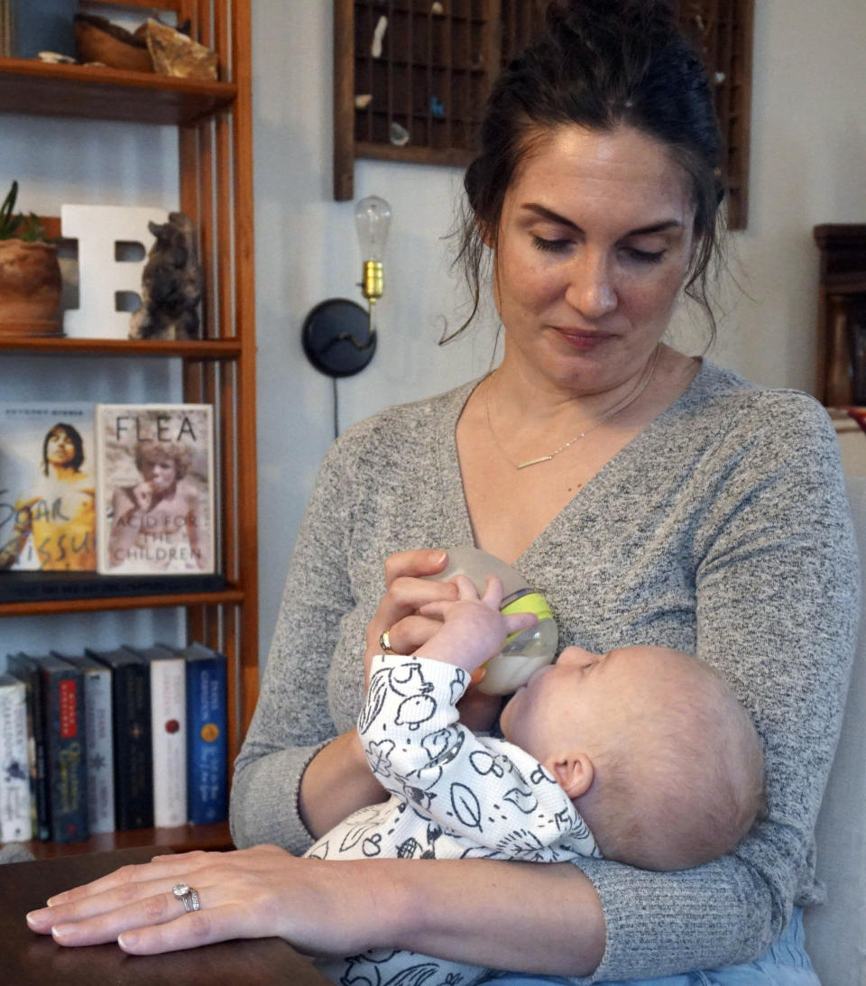 Jane Roberts feeds her son Dennis at her home in Idaho on Friday, March 1. Roberts, a high school teacher, plans to take next year off to care for her child. When Jane Roberts gave birth in November, she and her husband, both teachers, quickly realized sending baby Dennis to day care was out of the question. It was too costly, and they worried about finding a quality provider in their hometown of Pocatello, Idaho. (Carly Flandro/Idaho Education News via AP)