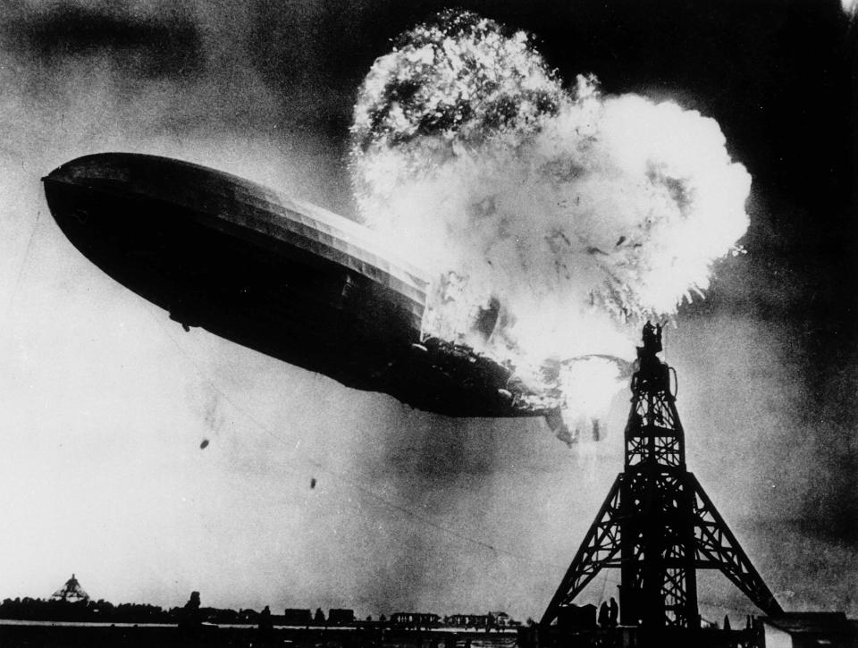 <p>This May 6, 1937 file photo, taken at almost the split second that the Hindenburg exploded, shows the 804-foot German zeppelin just before the second and third explosions send the ship crashing to the earth over the Lakehurst Naval Air Station in Lakehurst, N.J. The roaring flames silhouette two men, at right atop the mooring mast, dangerously close to the explosions. (AP Photo) </p>