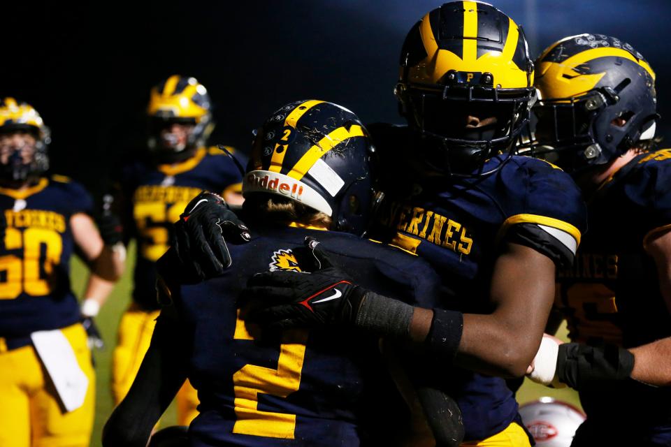 Prince Avenue players celebrate with Hudson Hill (2) after his touchdown during Friday's state quarterfinal victory.