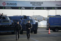 Gendarmes patrol at the entrance of the Rungis International Market, which supplies the capital and surrounding region with much of its fresh food, Monday, Jan. 29, 2024 south of Paris. Protesting farmers intended to encircle Paris with barricades of tractors, aiming to lay siege to France's seat of power in a battle with the government over the future of their industry shaken by the repercussions of the Ukraine war. (AP Photo/Christophe Ena)