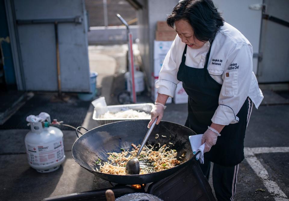 Chef and owner of Bangkok 96 in Dearborn Genevieve Vang is one of the 700,000 people without power in the area. Vang, her family and other workers emptied their restaurant coolers on Friday, Feb. 24, 2023 to cook food in a giant wok with propane tanks and present the food to the community for free. "The community supported us through COVID," said Vang's daughter Christine Vang, 27, "This is our opportunity to pay them back."