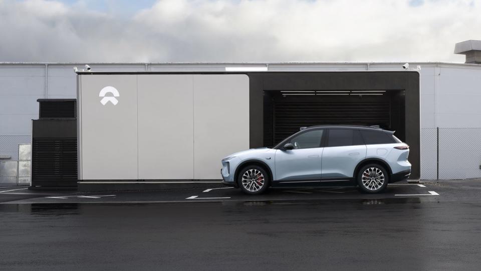 a silver car parked in front of a garage