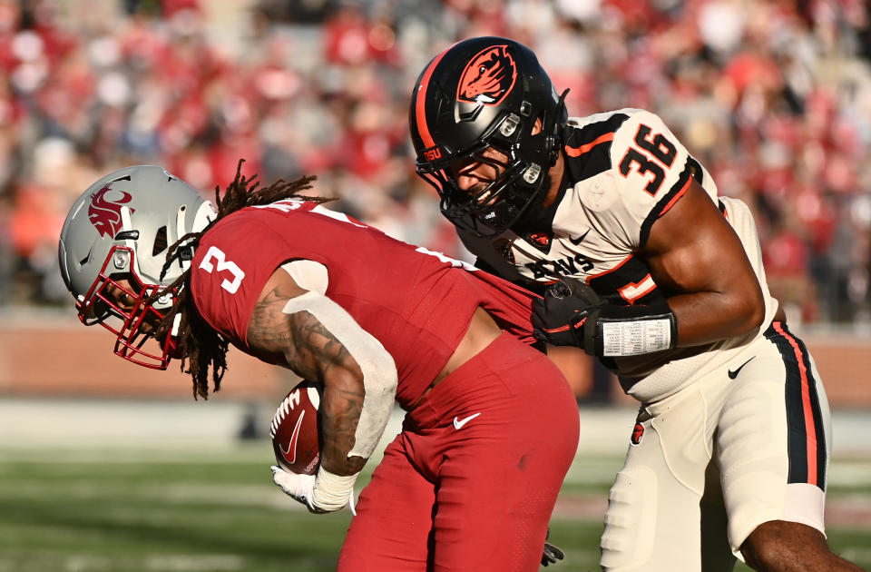 Oct 9, 2021; Pullman, Washington, USA; Washington State Cougars running back Deon McIntosh (3) is caught from behind by Oregon State Beavers linebacker Omar Speights (36) in the second half at Gesa Field at Martin Stadium. The Cougars won 31-24. Mandatory Credit: James Snook-USA TODAY Sports