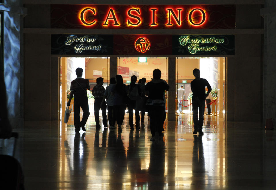 In this photo taken on Sept. 4, 2012, people make their way to the casino at Resorts World Sentosa in Singapore. In the Philippines, a $4 billion casino project will soon rise from reclaimed land on Manila Bay. In South Korea, foreign investors will break ground next year on a clutch of casino resorts offshore. The projects are part of a casino building boom rolling across Asia, where governments are trying to develop their tourism markets to capture increasingly affluent Asians with a penchant for gambling. (AP Photo/Wong Maye-E)