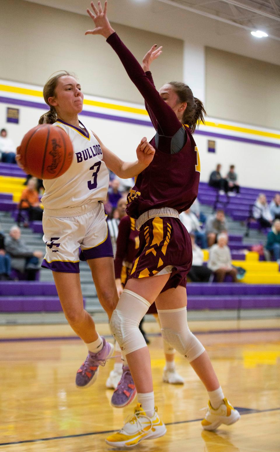 Bloom-Carroll's Emily Bratton (3) passes the ball around Berne Union's Sophia Kline (10) in girls varsity basketball action at Bloom-Carroll High School in Carroll, Ohio on January 20, 2022.