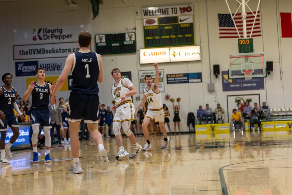 TJ Long and Matt Veretto watch as Vermont beats the buzzer to tie Yale on Dec. 2, 2023 at Patrick Gym. Long was fouled on the shot and converted the 4-point play as the Catamounts stunned the Bulldogs 66-65.