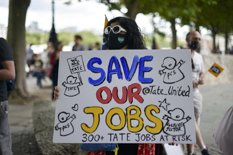 Theatre workers protest outside the National Theatre, against the mass redundancies of low-paid art jobs due to the Coronavirus outbreak, in London, Saturday, Aug. 1, 2020. Prime Minister Boris Johnson put some planned measures to ease the U.K.'s lockdown on hold Friday, saying the number of new coronavirus cases in the country is on the rise for the first time since May. He called off plans to allow venues, including casinos, bowling alleys and skating rinks, to open from Saturday, Aug. 1. (AP Photo/Alberto Pezzali)