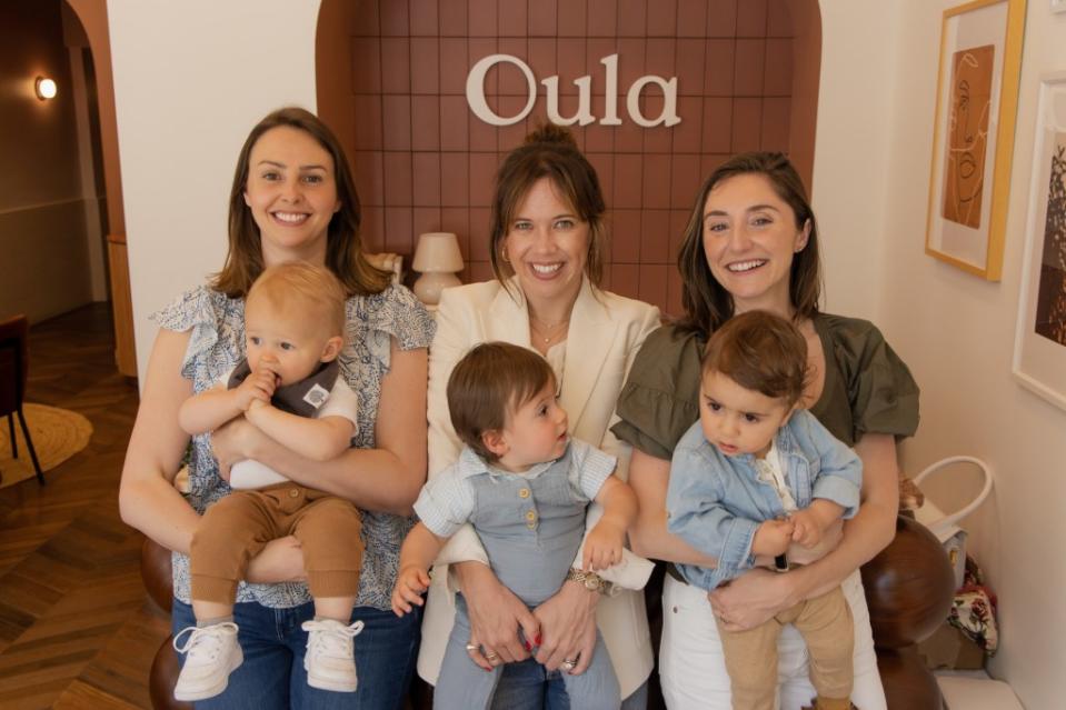 Oula founders Adrianne Nickerson (left) and Elaine Purcell (middle) holding babies at one of their clinics in New York City. The entrepreneurs say they are planning more clinics for the tri-state area. Courtesy of Oula