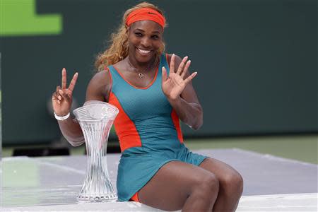 Mar 29, 2014; Miami, FL, USA; Serena Williams celebrates with the Butch Buchholz Trophy after winning the women's final of the Sony Open at Crandon Tennis Center. Williams defeated Li Na (not pictured) 7-5, 6-1. Mandatory Credit: Geoff Burke-USA TODAY Sports