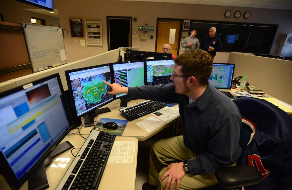 Andrew Kimball, a meteorologist at the National Weather Service office in Greenville, checks radar and satellites from his work station Wednesday.