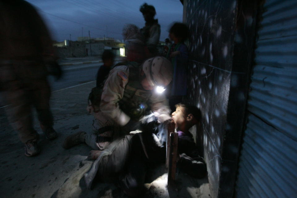 <p>An Iraqi boy is treated for a flesh wound in his back after U.S. Soldiers with the 1st Battalion, 5th Infantry Stryker Brigade Combat Team of the 25th Infantry Division out of Ft. Lewis, Washington killed his parents when their car approached soldiers, despite warning shots, during a dusk patrol January 18, 2005 in Tal Afar, Iraq. The car held an Iraqi family of which the mother and father were killed. According to the U.S. Army, six children in the in the car survived, one with a non-life threatening flesh wound. U.S. military said they are is investigating the incident. (Photo by Chris Hondros/Getty Images) </p>