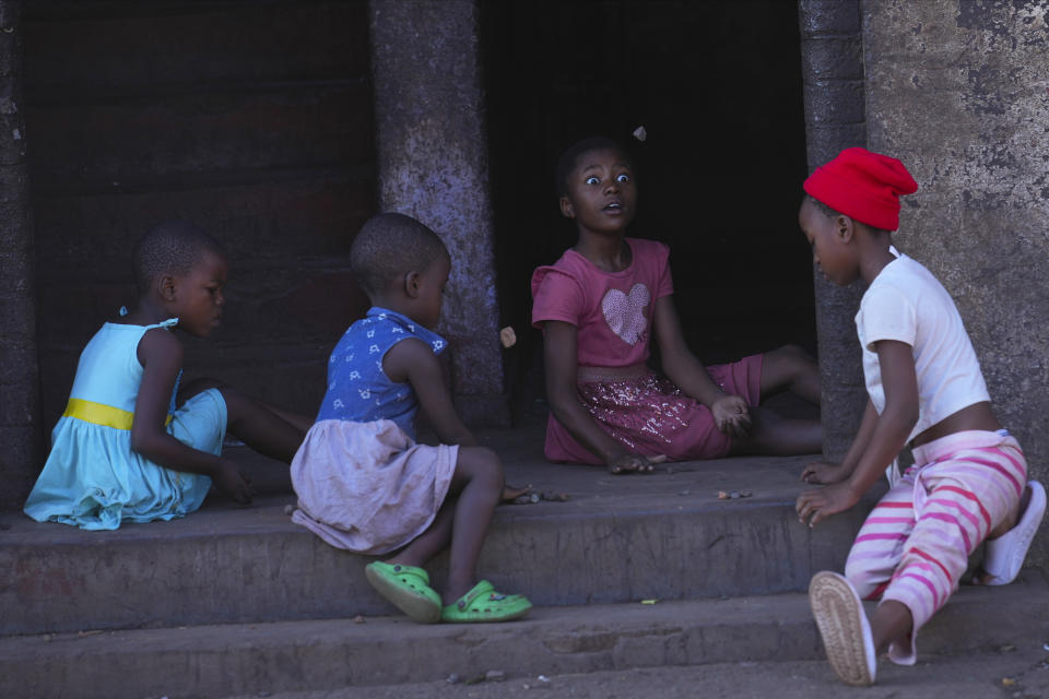 Children play a game with rocks at a block of flats in Harare, Zimbabwe, Saturday Nov. 18, 2023. Zimbabwe is battling a cholera outbreak that has resulted in more than 150 suspected deaths countrywide. Health experts, authorities and residents blame the outbreak on acute water shortages and lack of access to sanitation and hygiene services (AP Photo/Tsvangirayi Mukwazhi)