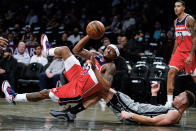 Washington Wizards' Bradley Beal (3) shoots over Brooklyn Nets' Blake Griffin (2) while falling down during the first half of an NBA basketball game Monday, Oct. 25, 2021, in New York. (AP Photo/Frank Franklin II)