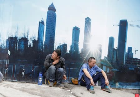 Workers rest outside a construction site in Beijing's central business district, China, July 15, 2016. REUTERS/Jason Lee