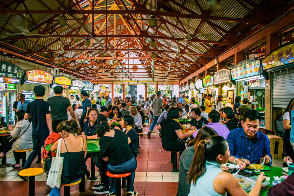 Locals enjoying food from a hawker centre in Singapore, illustrating a story on DBS Paylah! hawker promo.