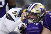 Washington quarterback Dylan Morris, right, is tackled by California linebacker Braxten Croteau (52) during the first half of an NCAA college football game, Saturday, Sept. 25, 2021, in Seattle. (AP Photo/Elaine Thompson)