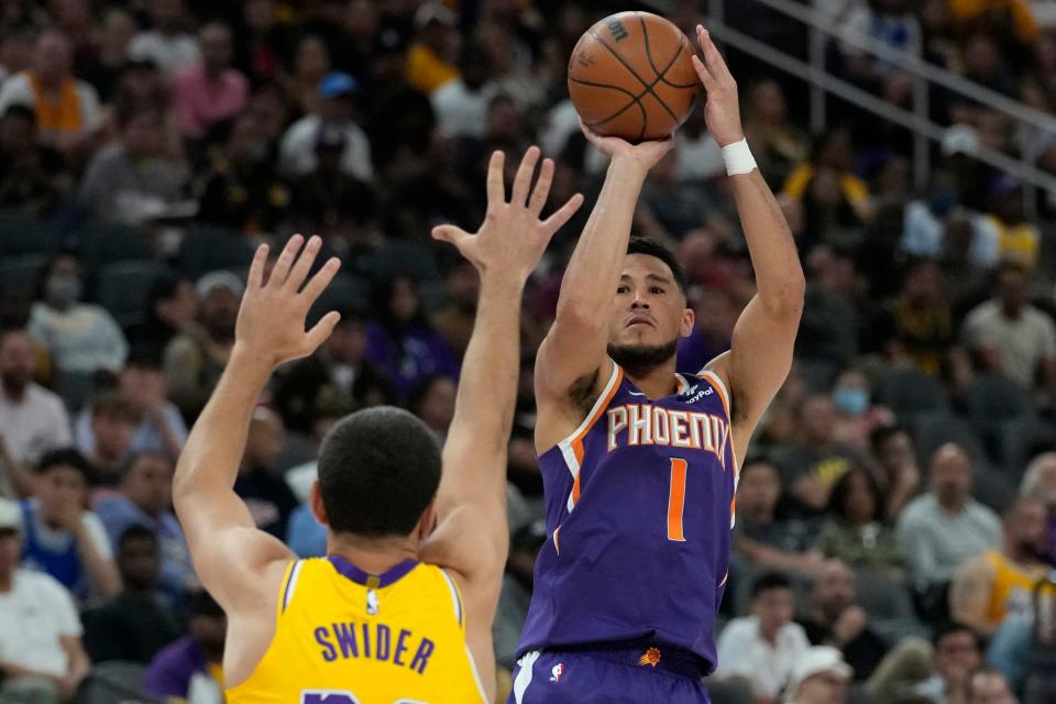 Phoenix Suns guard Devin Booker (1) shoots against Los Angeles Lakers forward Cole Swider (20) during the first half of a preseason NBA basketball game Wednesday, Oct. 5, 2022, in Las Vegas.