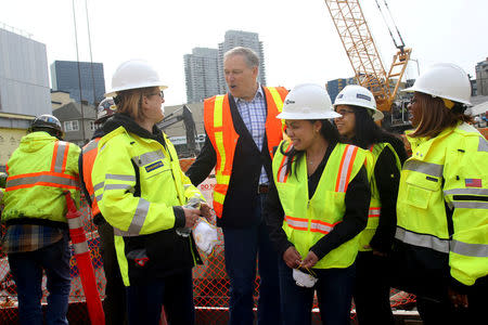 Washington state Governor Jay Inslee speaks with some of the crew at the conclusion of Seattle’s tunnel-drilling machine, Bertha, the world's largest tunnel-boring machine breaking through in Seattle, Washington, U.S., April 4, 2017. REUTERS/Karen Ducey