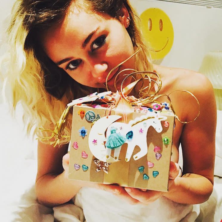 Miley Cyrus holds a birthday gift