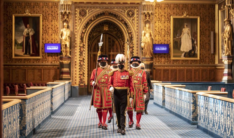 Masked Yeoman warders march along the Royal gallery to take part in the traditional 