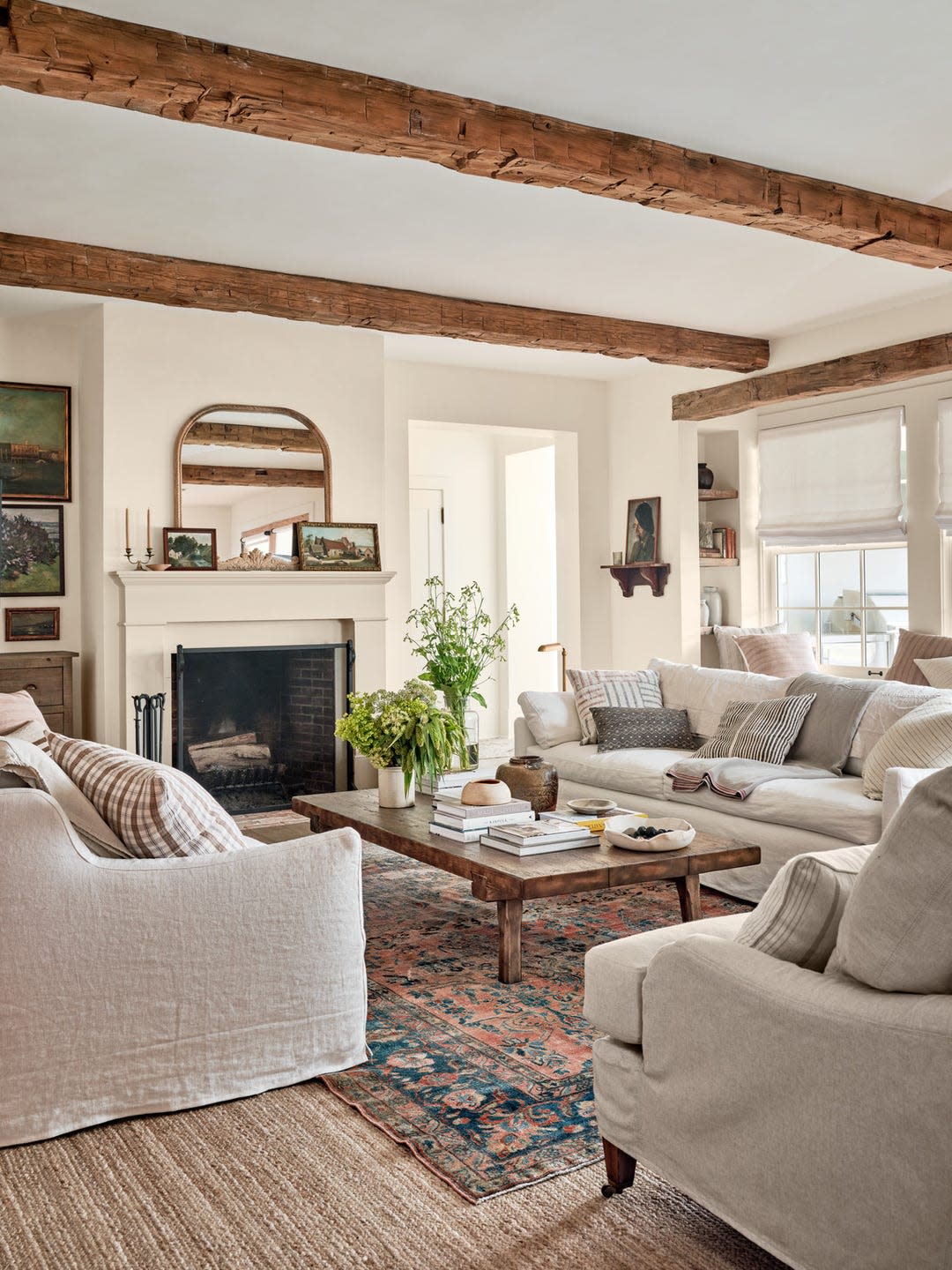 farmhouse living room with barn beams, neutral furniture