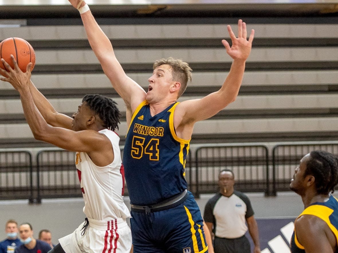 Thomas Kennedy goes for the block against the University of Guelph. (University of Windsor Athletics - image credit)