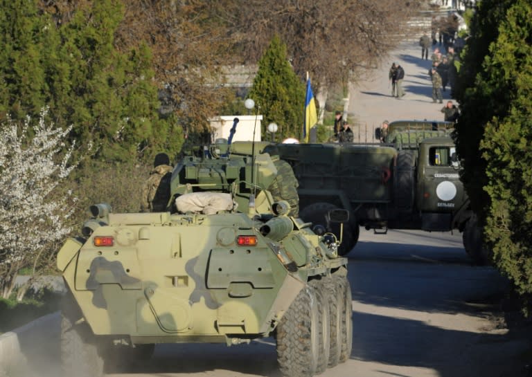 Russian soldiers storm a Ukrainian military air base in the small city of Belbek near the Crimean city of Sevastopol on March 22, 2014