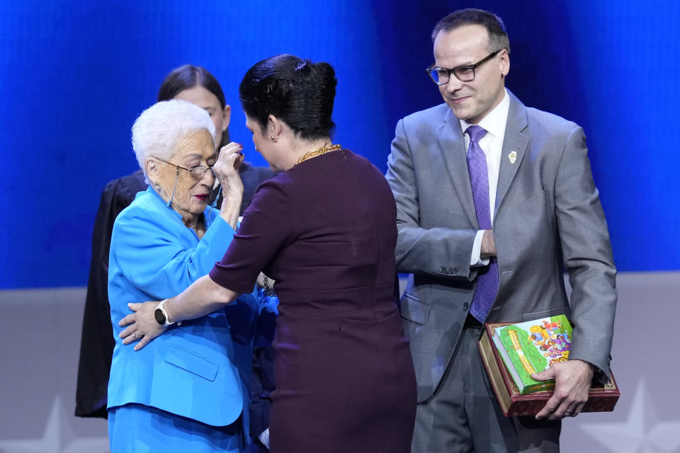 Illinois Comptroller Susana A. Mendoza's mother Susana, blesses her daughter as Mendoza's husband David Szostak watches after she was sworn for the third time as comptroller during ceremonies Monday, Jan. 9, 2023, in Springfield, Ill. (AP Photo/Charles Rex Arbogast)