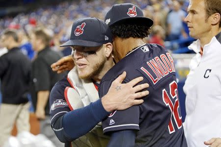 Cleveland Indians catcher Roberto Perez (55) and shortstop Francisco Lindor (12) celebrate after beating the Toronto Blue Jays in game five of the 2016 ALCS playoff baseball series at Rogers Centre. Mandatory Credit: John E. Sokolowski-USA TODAY Sports