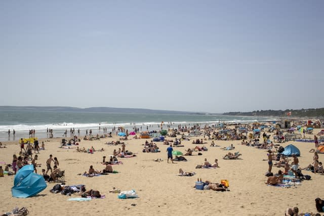 People enjoy the sunshine on the beach in Bournemouth, Dorset