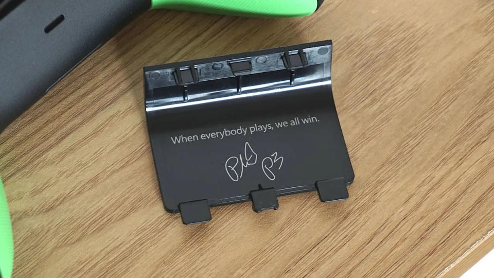 The inside of the battery cover on the Xbox 20th Anniversary controller with the message 