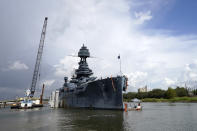 Work continues at the USS Texas in preparation for moving and repairs Tuesday, Aug. 30, 2022, in La Porte, Texas. The USS Texas, which was commissioned in 1914 and served in both World War I and World War II, is scheduled to be towed down the Houston Ship Channel Wednesday to a dry dock in Galveston where it will undergo an extensive $35 million repair. (AP Photo/David J. Phillip)