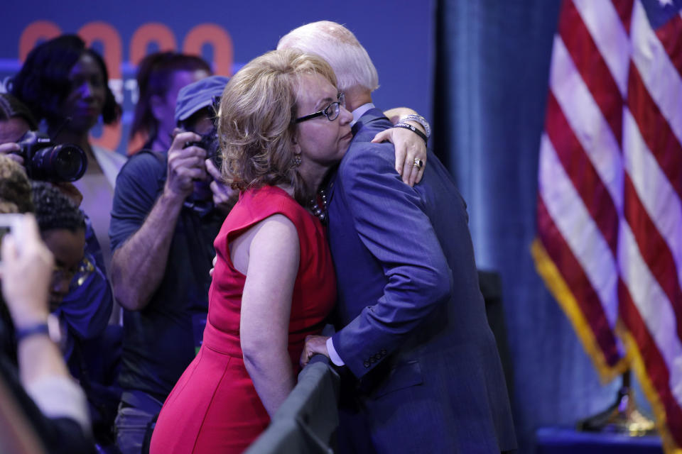 Former Vice President and Democratic presidential candidate Joe Biden, right, hugs former Rep. Gabby Giffords during a gun safety forum Wednesday, Oct. 2, 2019, in Las Vegas. (AP Photo/John Locher)