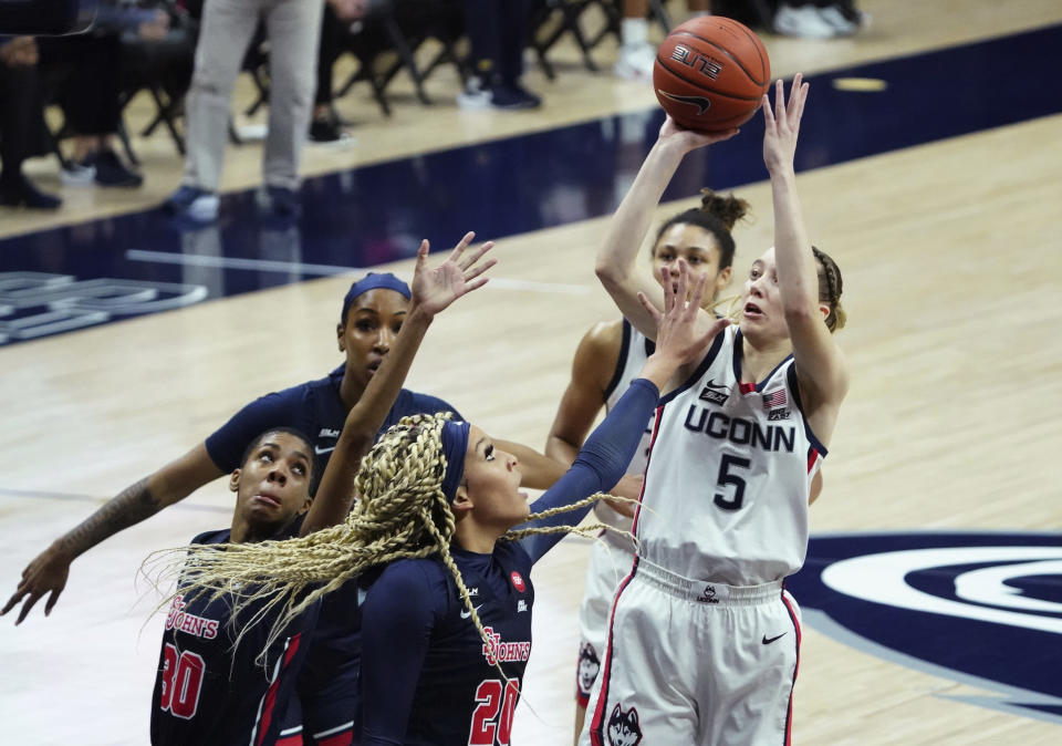 Connecticut guard Paige Bueckers (5) shoots against St. John's forward Rayven Peeples (20) during the first half of an NCAA college basketball game Wednesday, Feb. 3, 2021, in Storrs, Conn. (David Butler II/Pool Photo via AP)