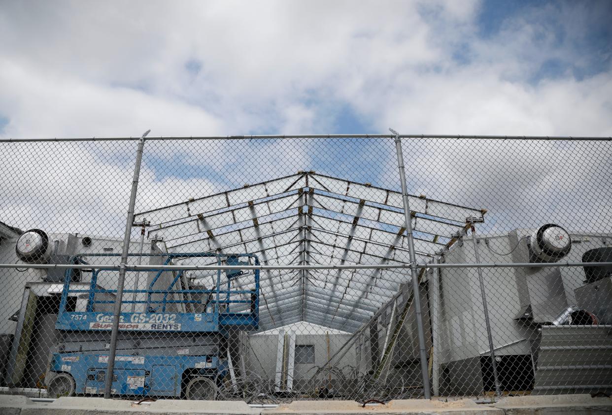 Workers disassemble the Greene County trailer jail located near North Campbell Avenue and West Nichols Street on Friday, July 29, 2022. With the new jail facility open, the trailer jail is no longer needed.